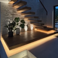 Modern wooden staircase illuminated by LED lighting