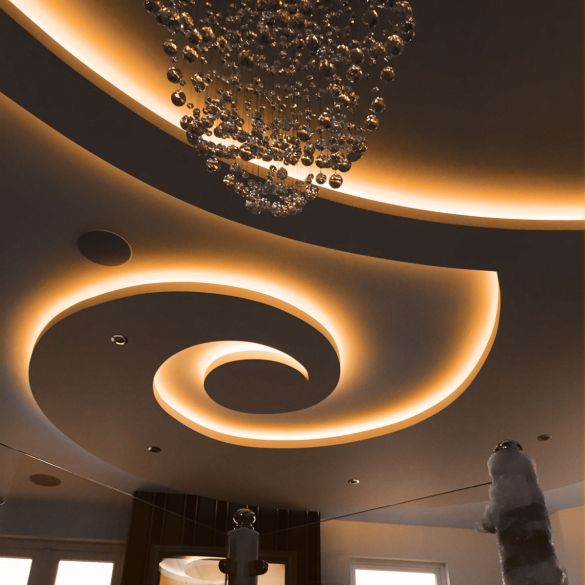 Cove and ceiling illuminated by orange coloured LED linear strip lighting