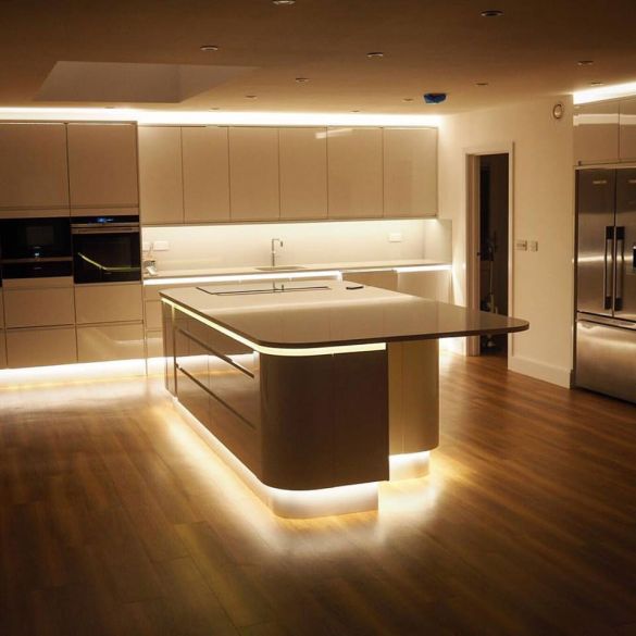 Kitchen worktop and plinths illuminated by white coloured LED linear strip lighting