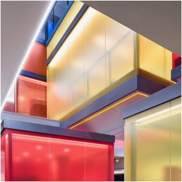 Modular red, yellow and orange glass partitions. Ceilings illuminated by white coloured LumiFlex (Linear Neon) lighting